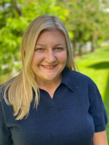 Dr. Lara Brewer Headshot. Nature background.